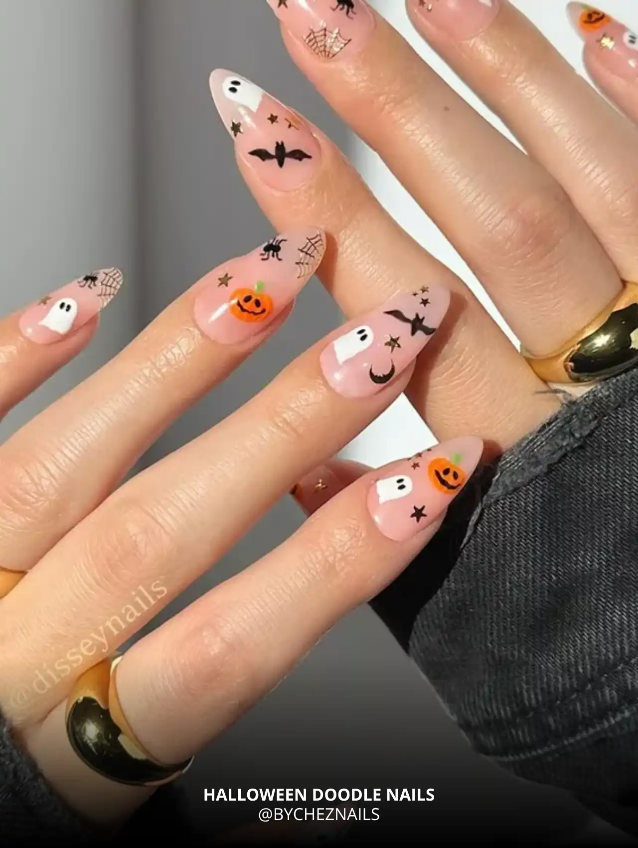 Colorful Halloween doodles with ghosts, bats, and pumpkins on nude base, trendy Halloween nails