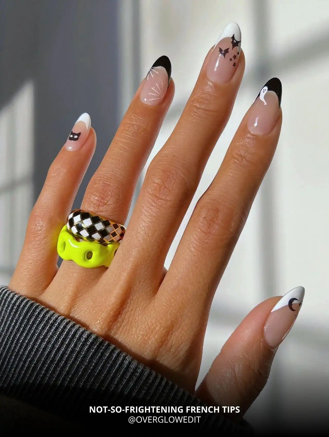 Not-So-Frightening French tips with bats, ghosts, and stars, trendy Halloween nails