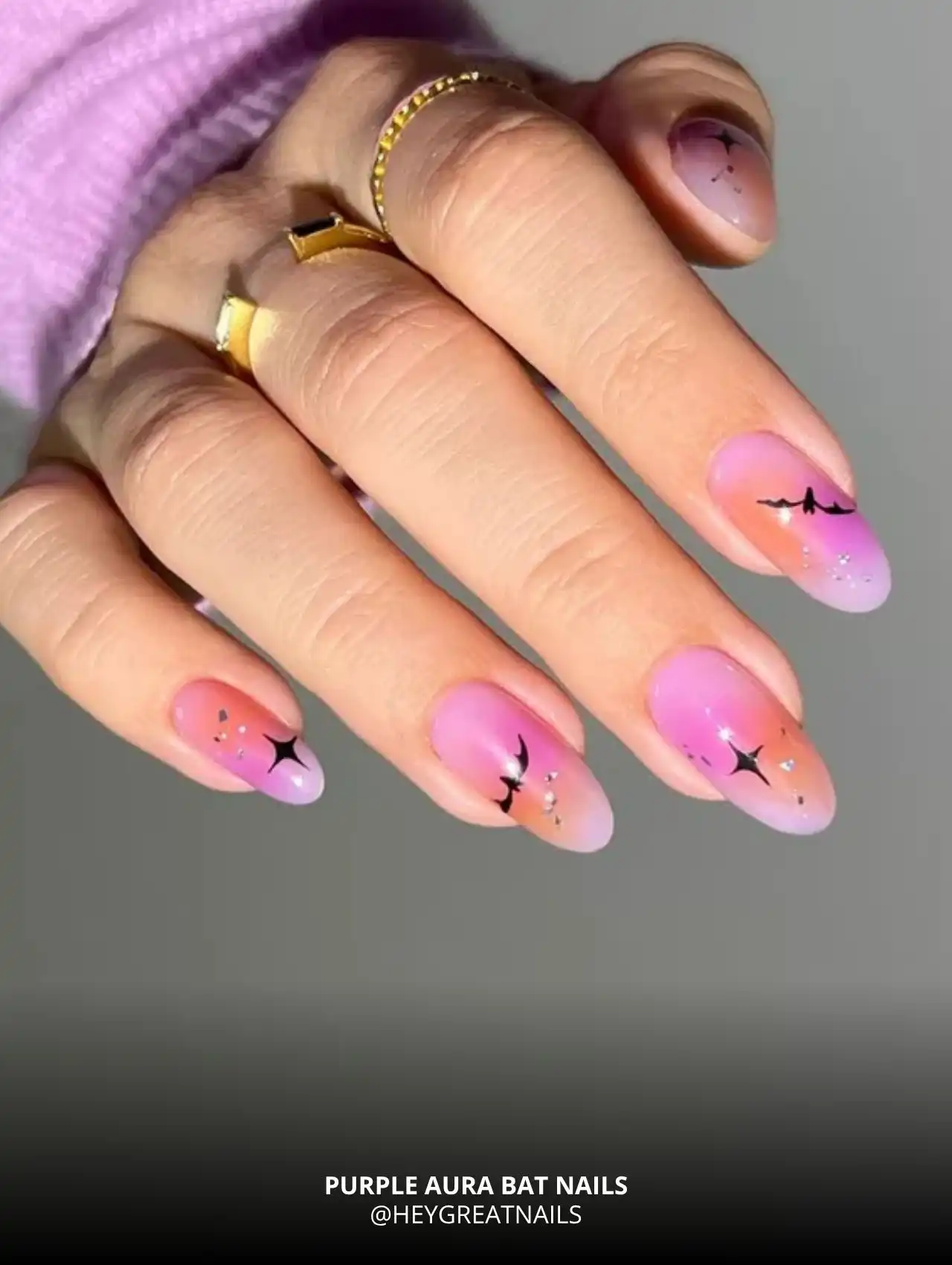 Purple aura nails with flying bats and sparkle accents, trendy Halloween nails