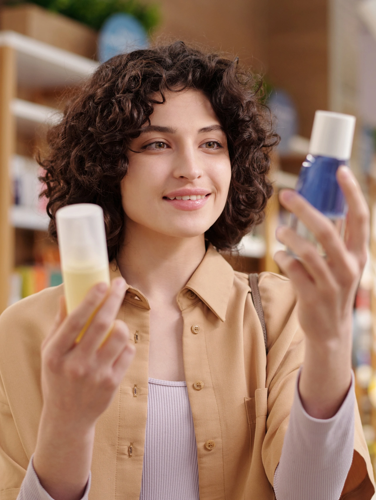 Woman examining two skincare products while shopping during Black Friday Sales beauty deals at a cosmetics store.