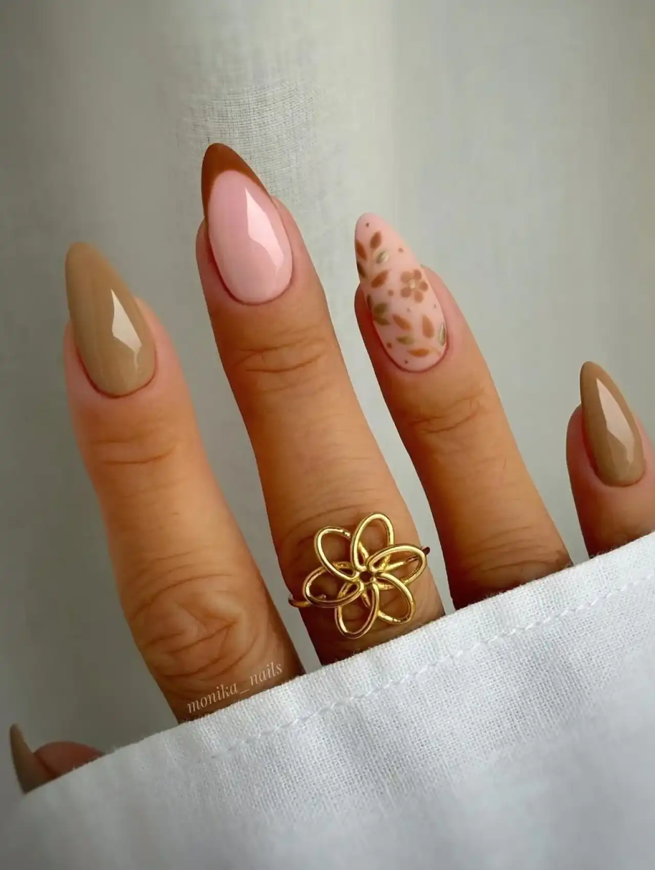 Festive orange and brown Thanksgiving nails with glitter accents