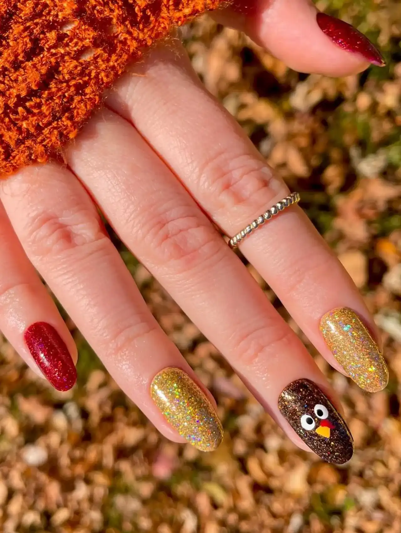 Glittery Thanksgiving nails with turkey nail art accent