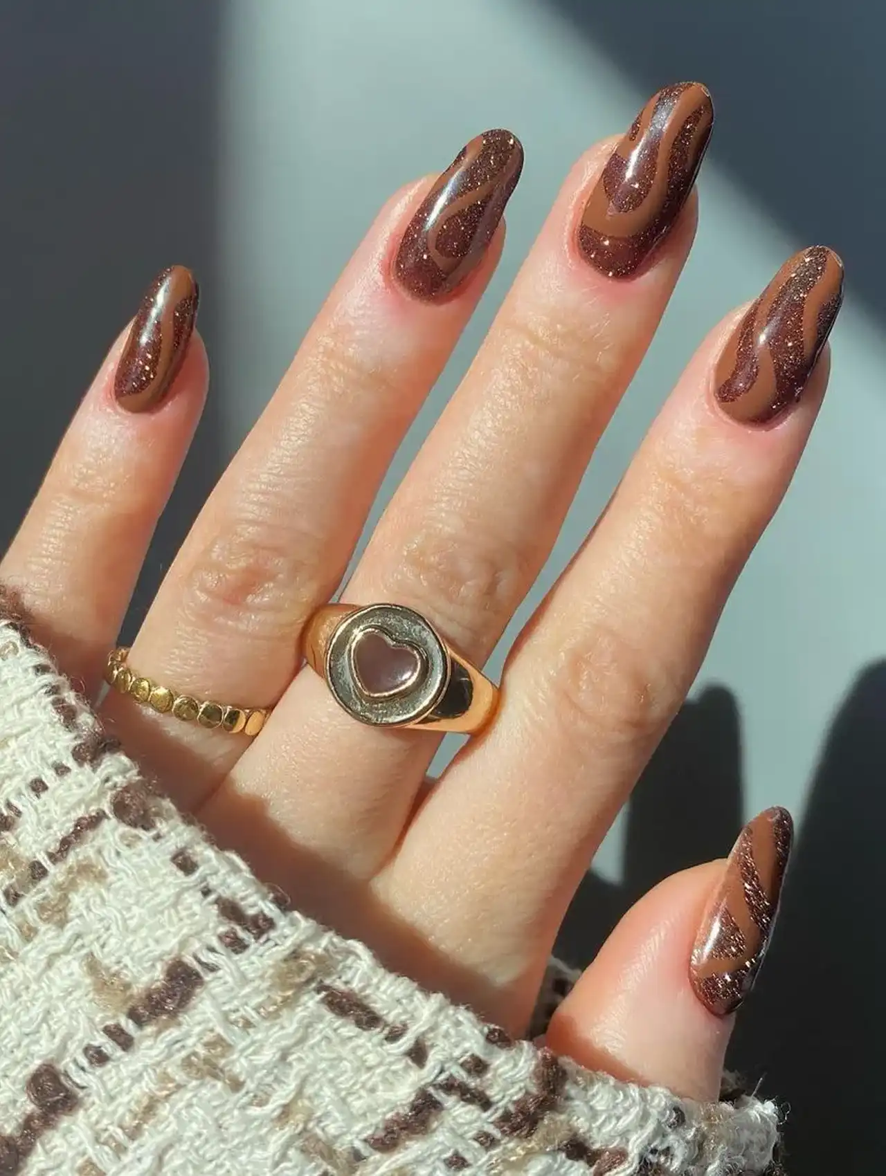 Hot chocolate november nail design with glossy brown swirls
