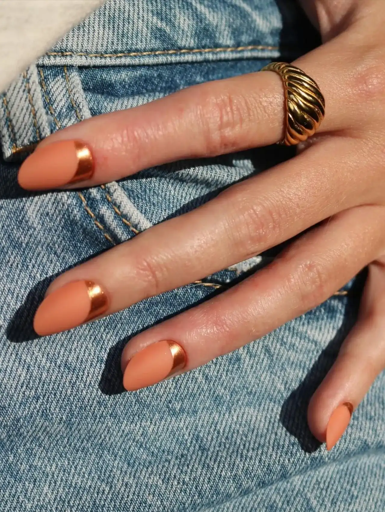 Two-tone orange Thanksgiving nails with metallic accents