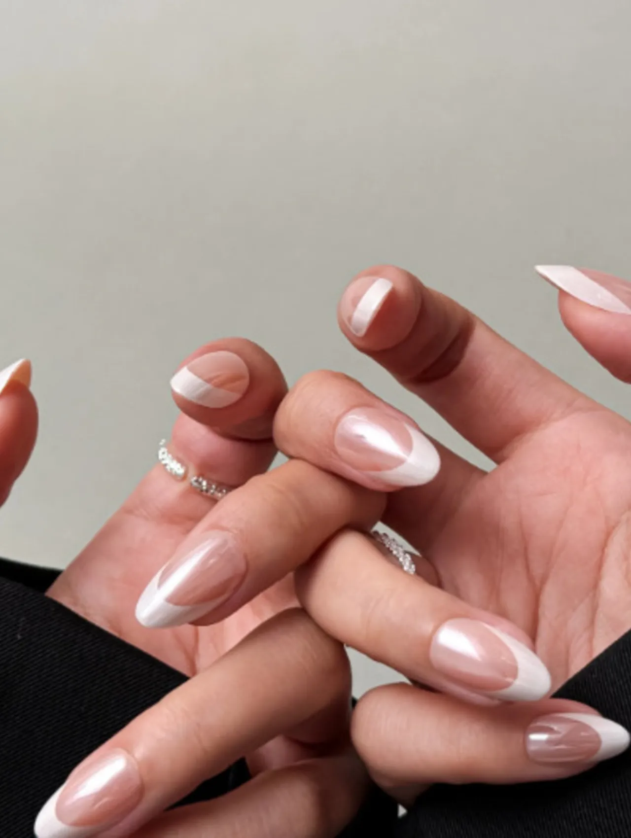 Celebrity Christmas Nail Inspo featuring elegant white French manicure with a glossy modern twist.