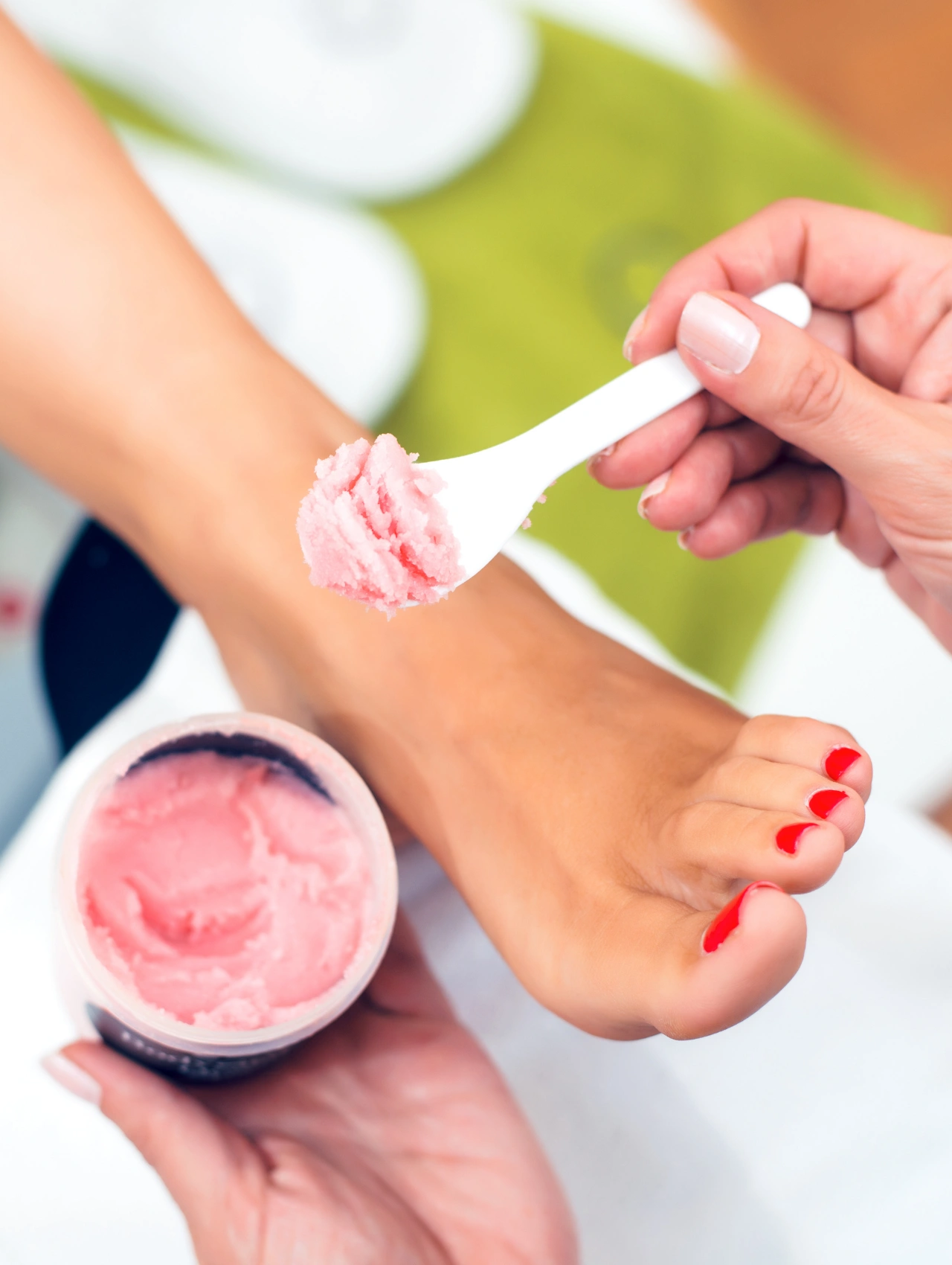 Christmas Pedicures spa treatment with exfoliating scrub applied to feet, highlighting festive holiday pedicure care