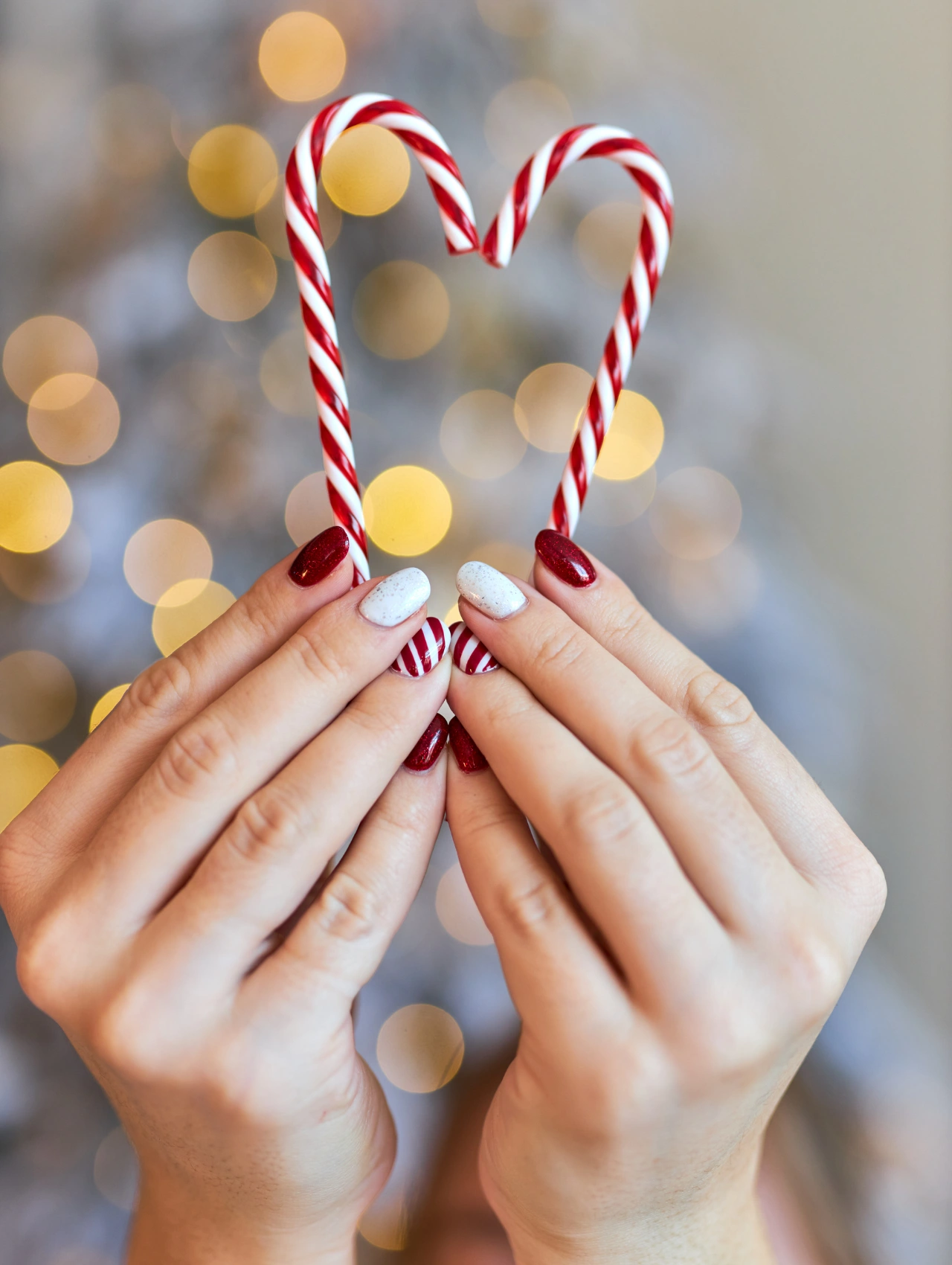 Candy Cane Christmas Nails with red glitter, white shimmer, and striped peppermint-inspired designs.