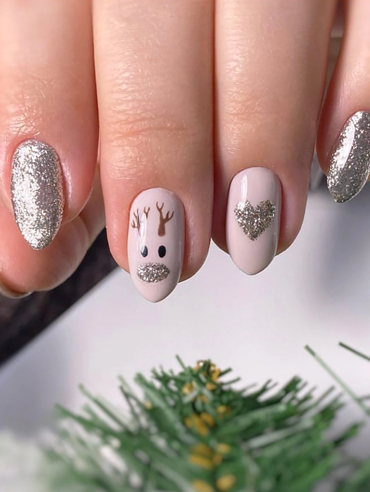 Various Christmas Nail styles featuring reindeer nail art, glitter accents, and neutral tones.