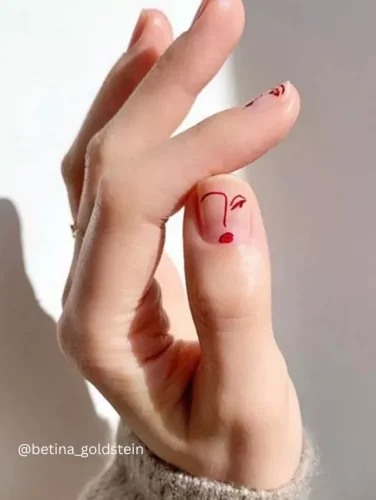 A true work of art at your fingertips! This chic minimalist nail design features a single-line face sketch in bold red on a nude base, exuding effortless sophistication and creativity. Perfect for art lovers and those who appreciate abstract elegance! 🖌️❤️💅