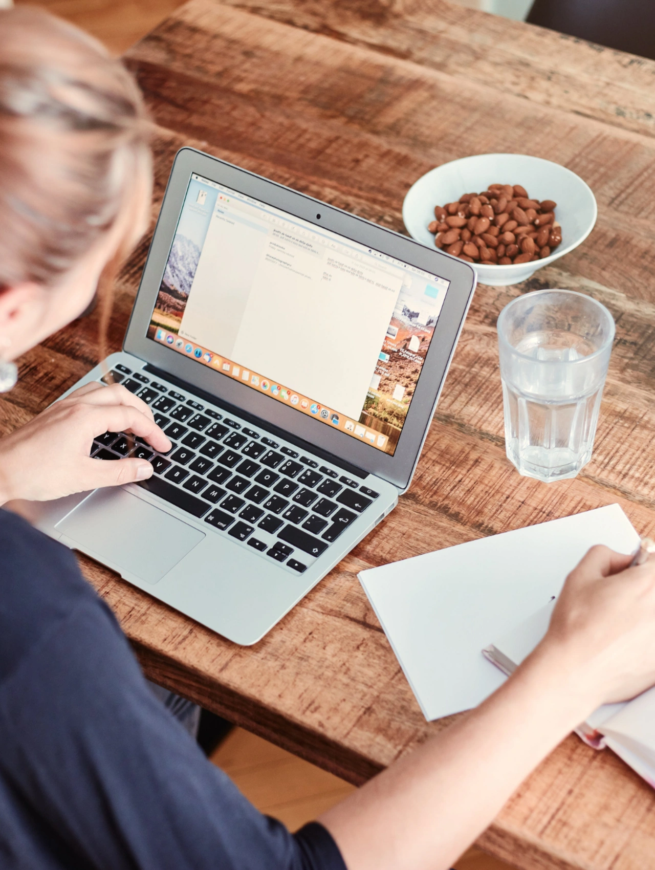 Best apps for productivity shown through a workspace setup with a laptop, notebook, and focused work environment.