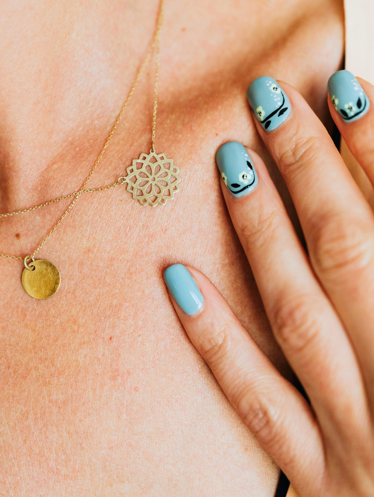 Dusty Blue Floral Touch January Nails with muted blue polish and tiny floral nail art.