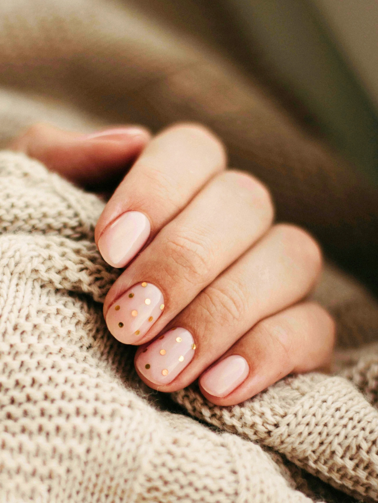 Soft Blush Polka Dots January Nails with light pink polish and subtle gold dot accents.