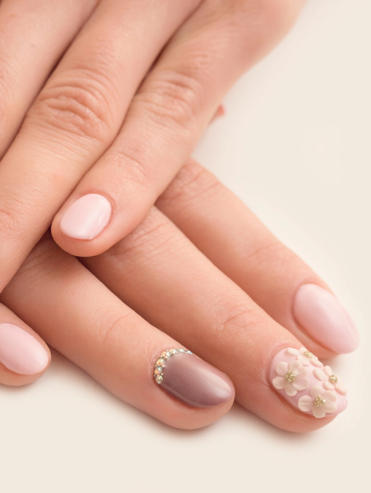 Soft Pink Crystal Accent January Nails with pale pink polish and crystal nail art detail.