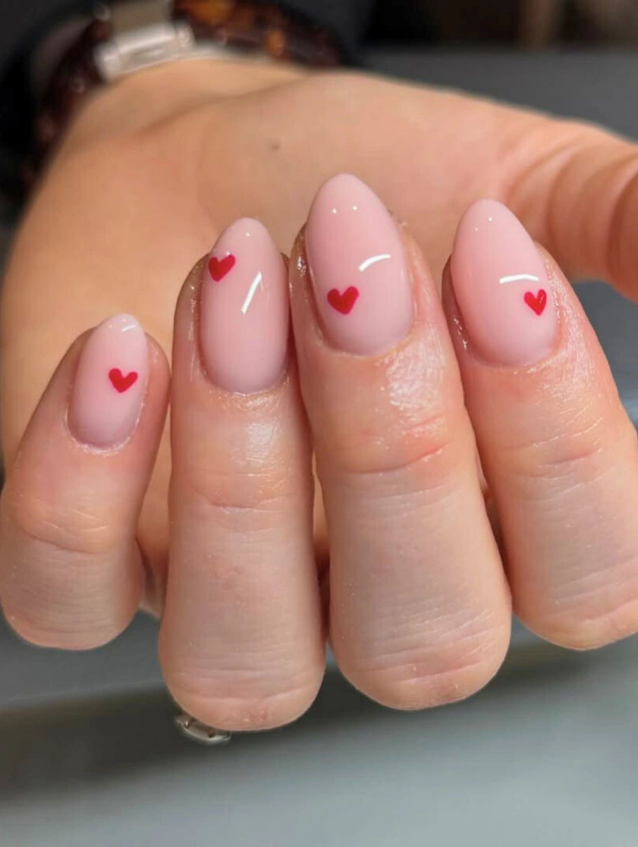 Easy DIY Valentine’s Day Nail Art featuring minimal red heart accents on a soft pink base