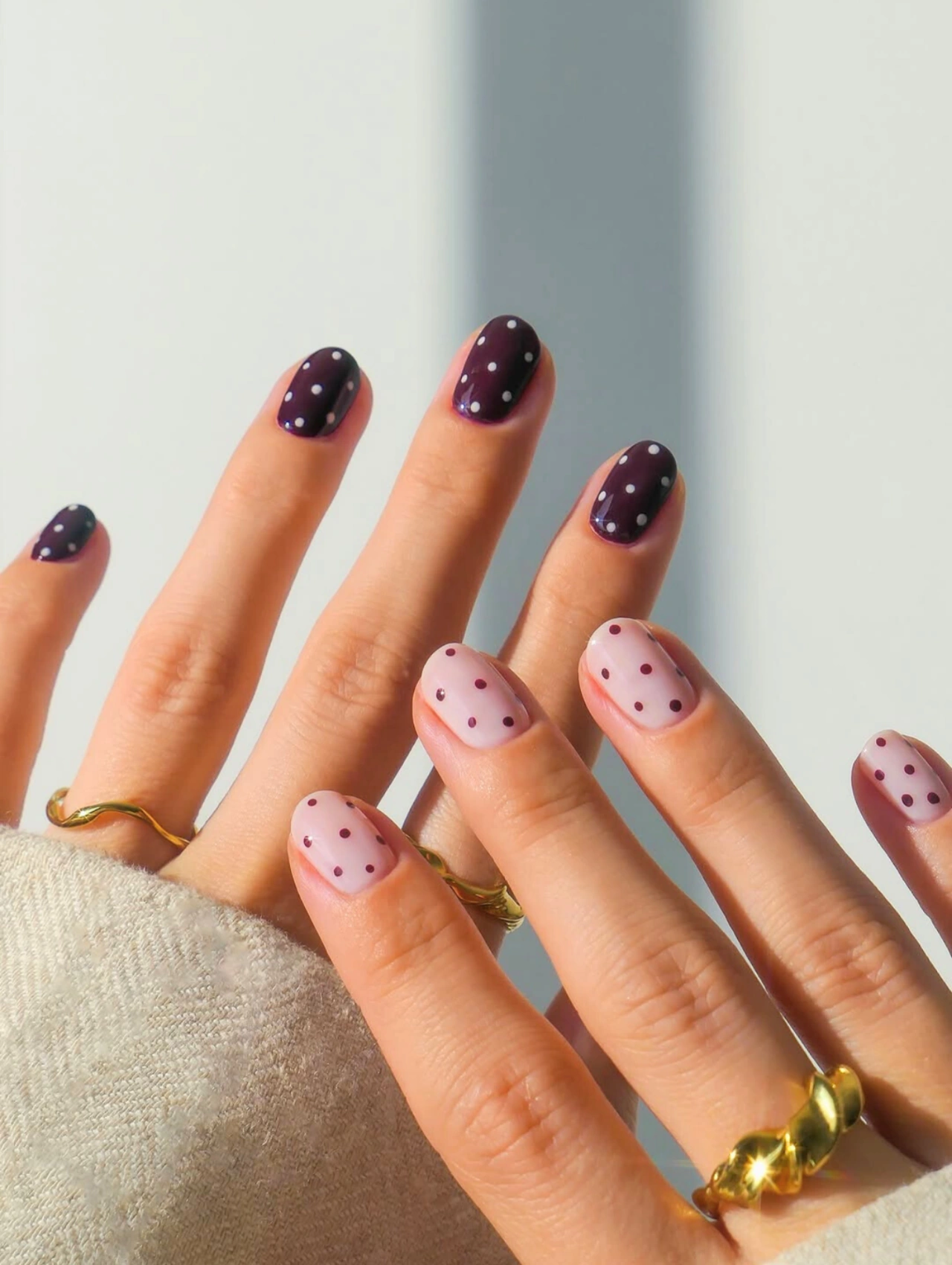 Easy DIY Valentine’s Day Nail Art featuring a pink and burgundy polka dot design on short rounded nails