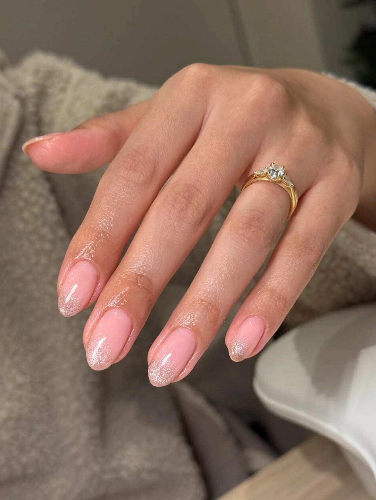 Easy DIY Valentine’s Day Nail Art with sheer pink polish and delicate glitter for a soft romantic manicure