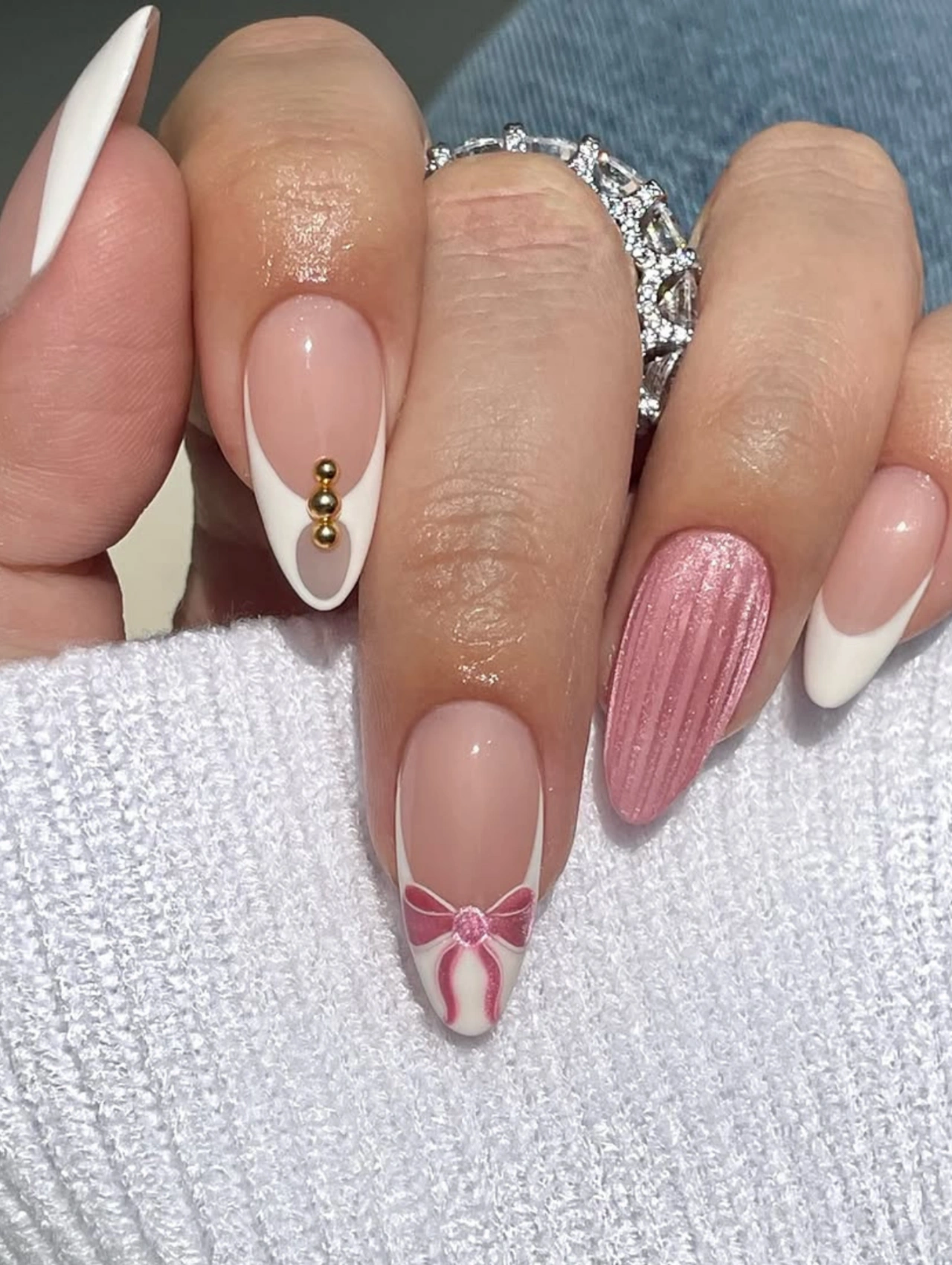 Elegant White and Pink Bow Valentineโs Nails Almond with almond-shaped nails, soft pink base, white tips, and bow accents.