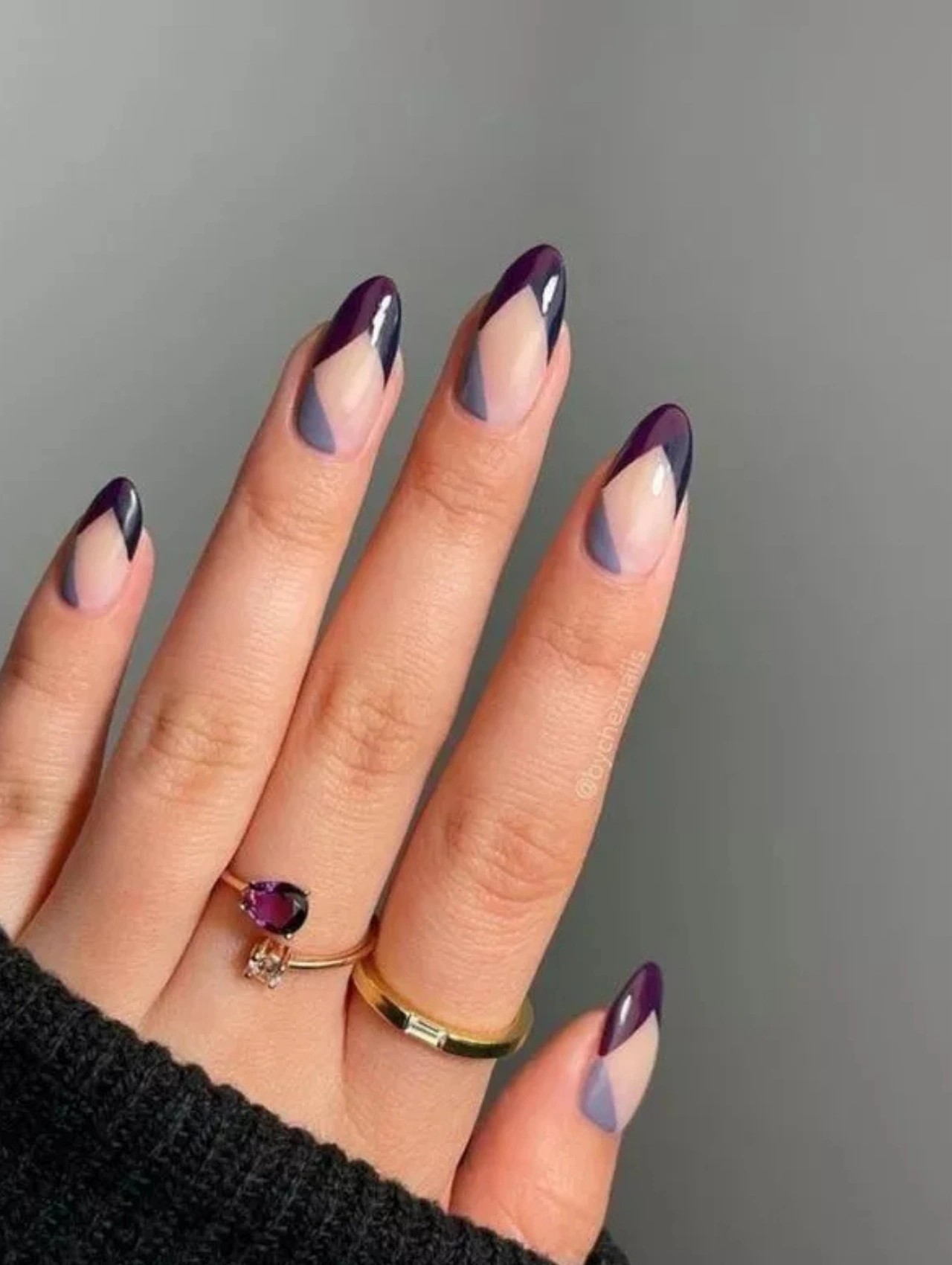 Geometric purple manicure with layered winter tones, offering a modern twist on December Nails
