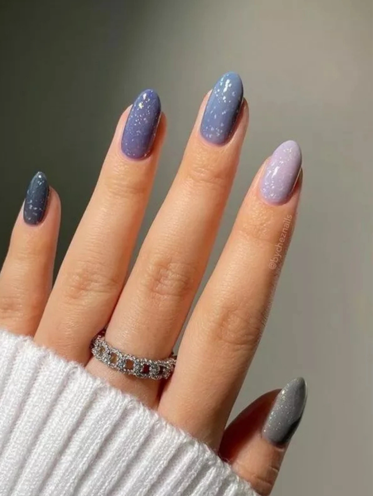 Gradient blue and lavender glitter manicure, adding a cool winter vibe to December Nails