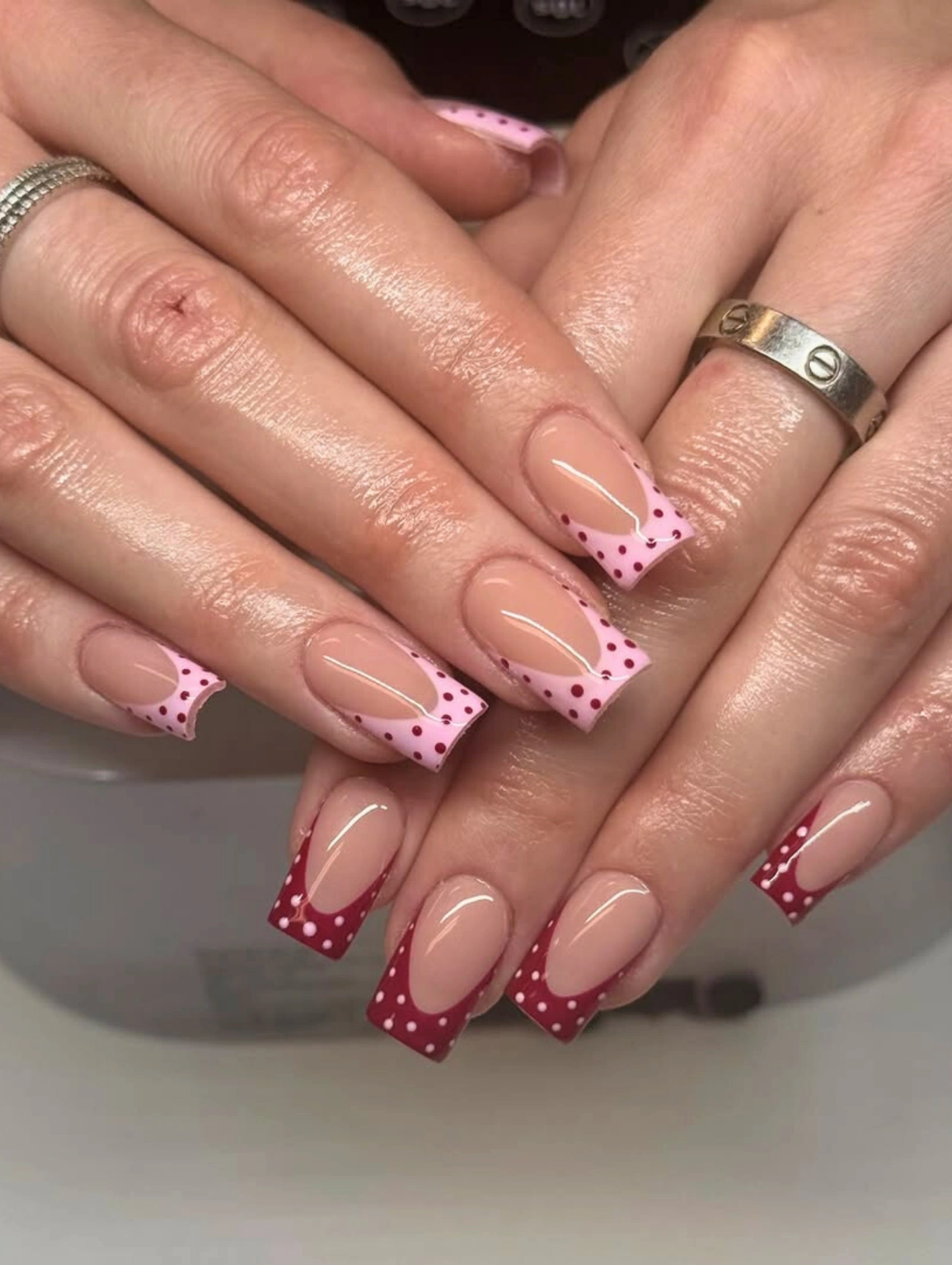 Pink Polka Dot French Coffin Valentine’s Nails with nude bases and dotted pink and red French tips.
