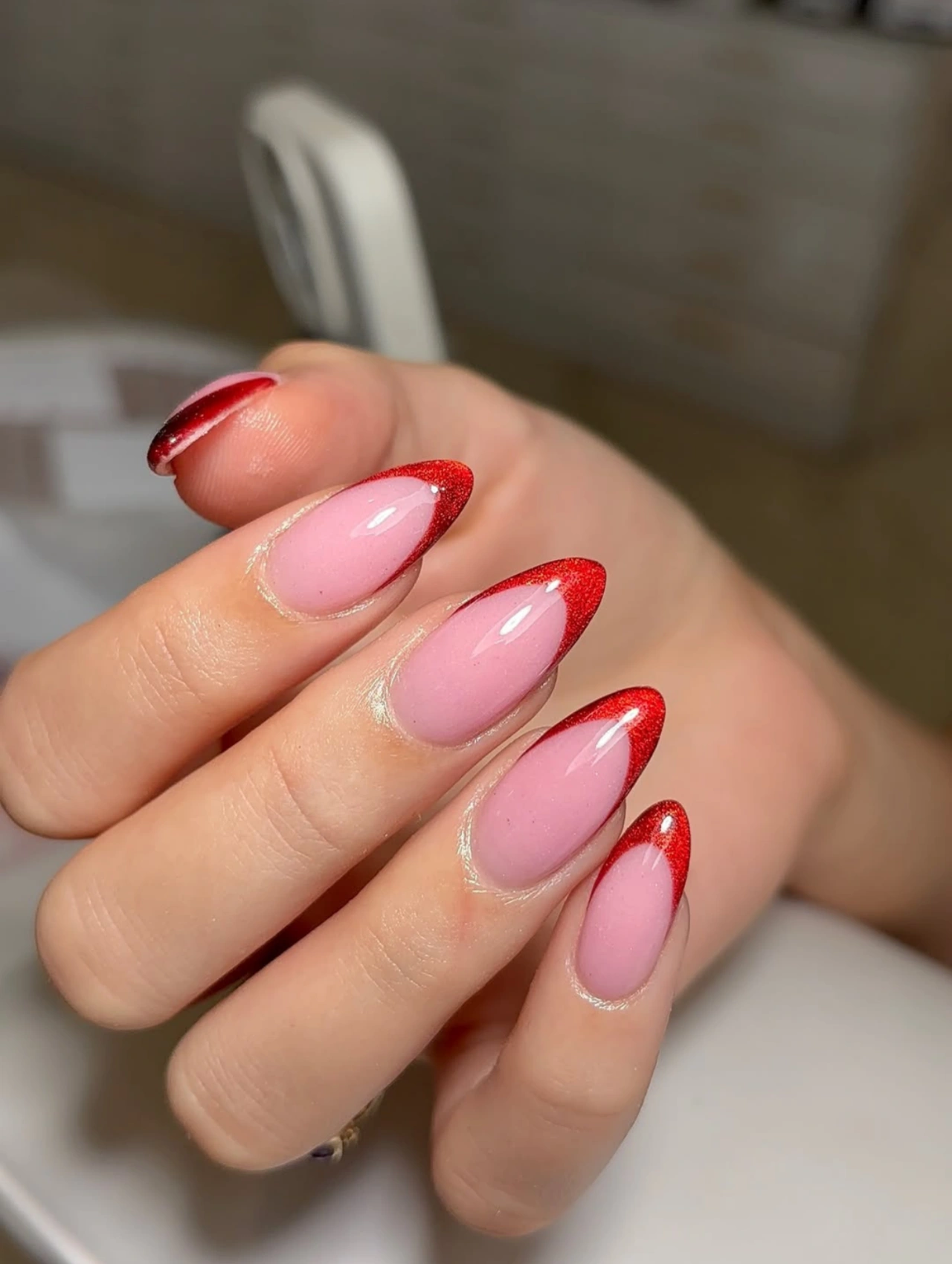 Red French Almond Valentine’s Nails Dip Powder with pink bases and bold red French tips.