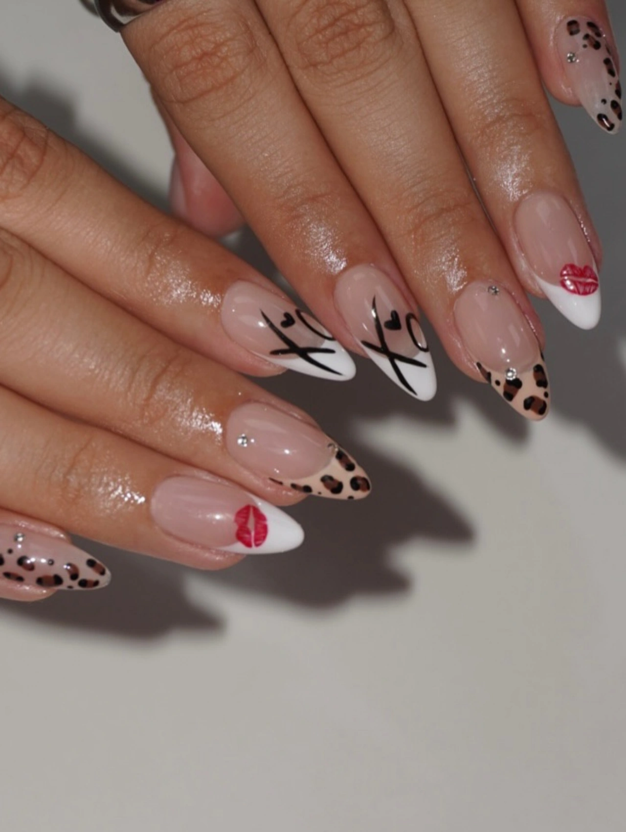 Red Glam XO Valentines Nails Acrylic featuring acrylic nails with XO lettering, heart details, and bold red accents.