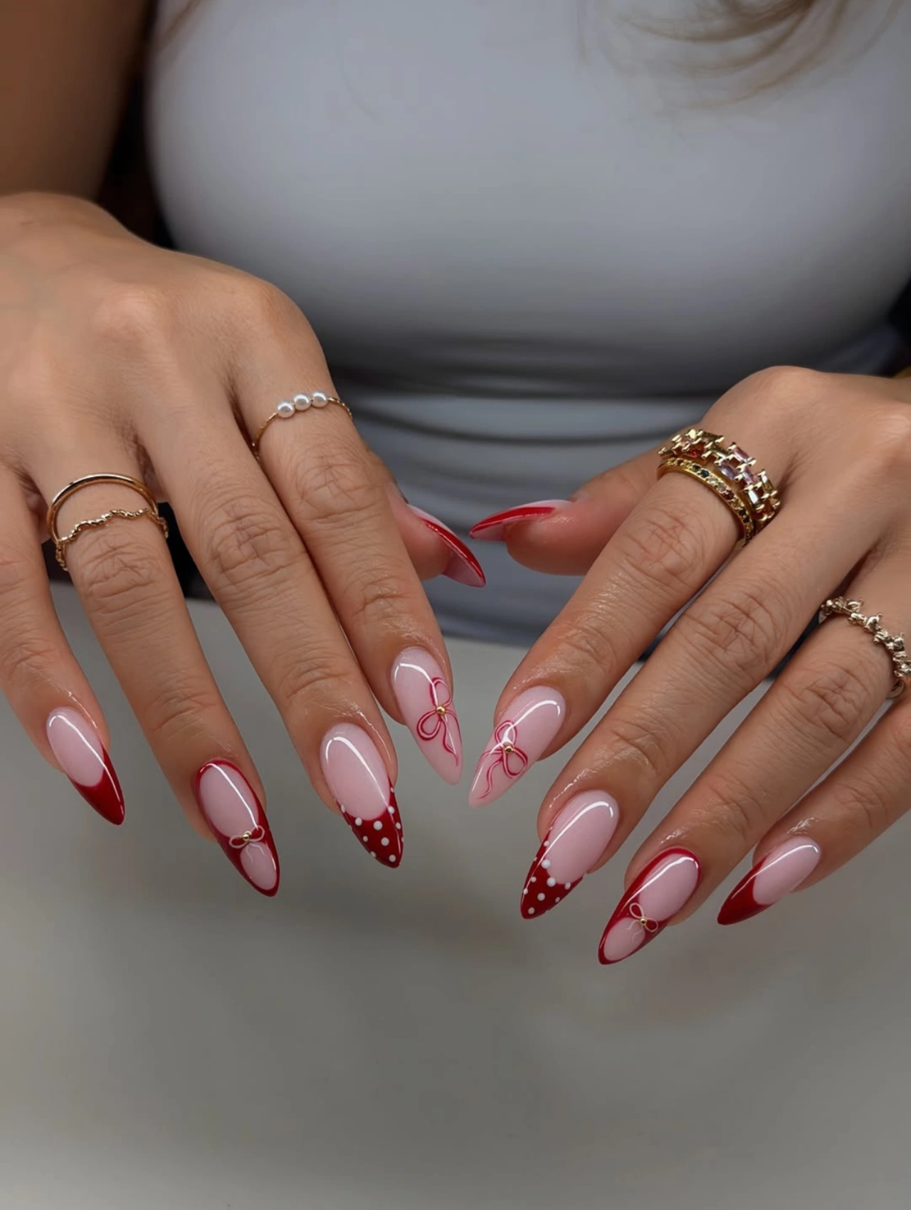 Romantic Red French Bow Valentineโs Nails Almond featuring almond-shaped nails with red French tips, bow details, and heart accents.