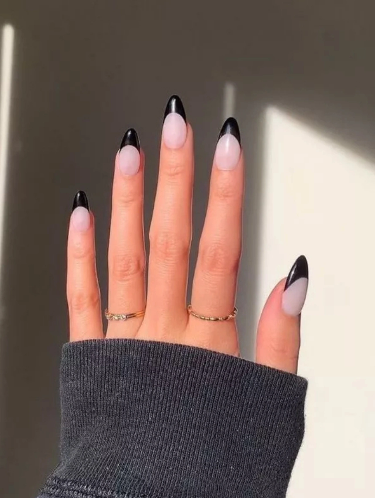 Black French tip manicure with a modern twist, ideal for bold and elegant December Nails