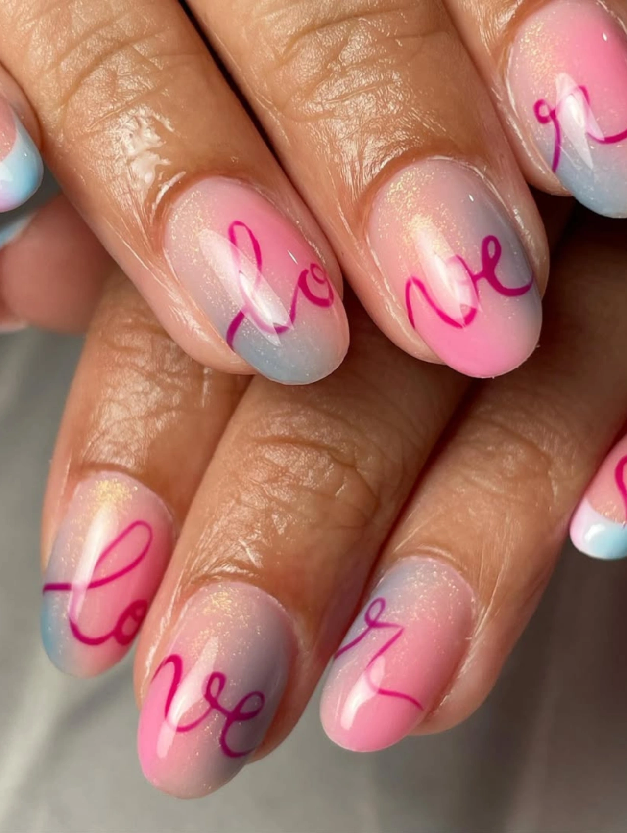 Soft Pink Love Valentines Nails Acrylic with pastel pink and blue acrylic nails featuring handwritten love lettering.