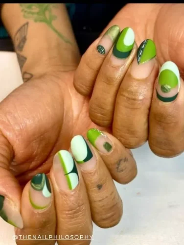 Stylish green gradient nail art on almond-shaped nails