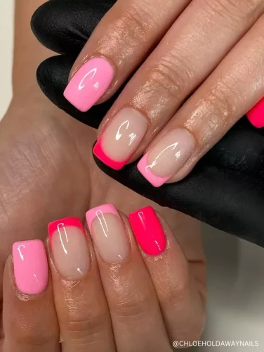 A stylish neon pink French tip and solid pink nail design featuring a modern square shape with glossy finishes.