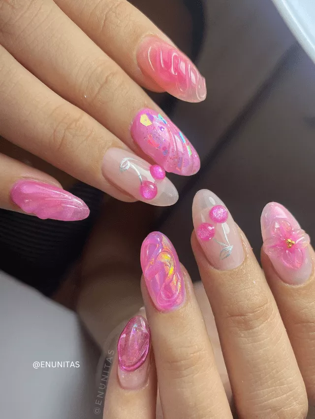 Pink 3D jelly nails with intricate cherry, floral, and abstract designs.