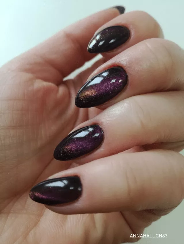 Deep purple galaxy velvet nails with a shimmering cat-eye effect.