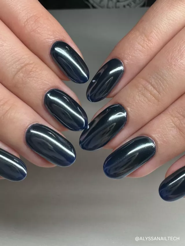 A sleek and glossy midnight blue-black chrome nail design with a mirror-like finish.