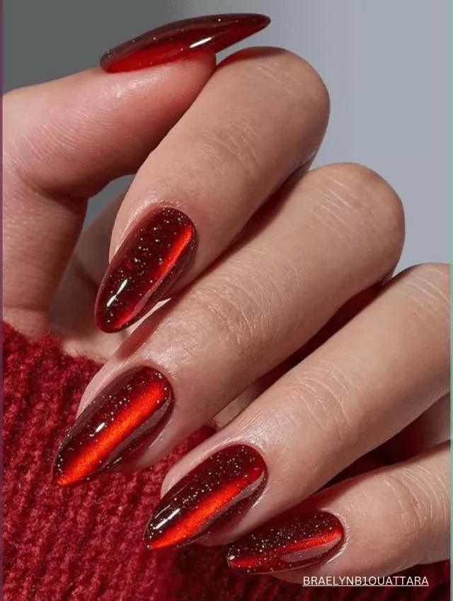 Bold ruby red velvet nails with a glossy, cat-eye shimmer.