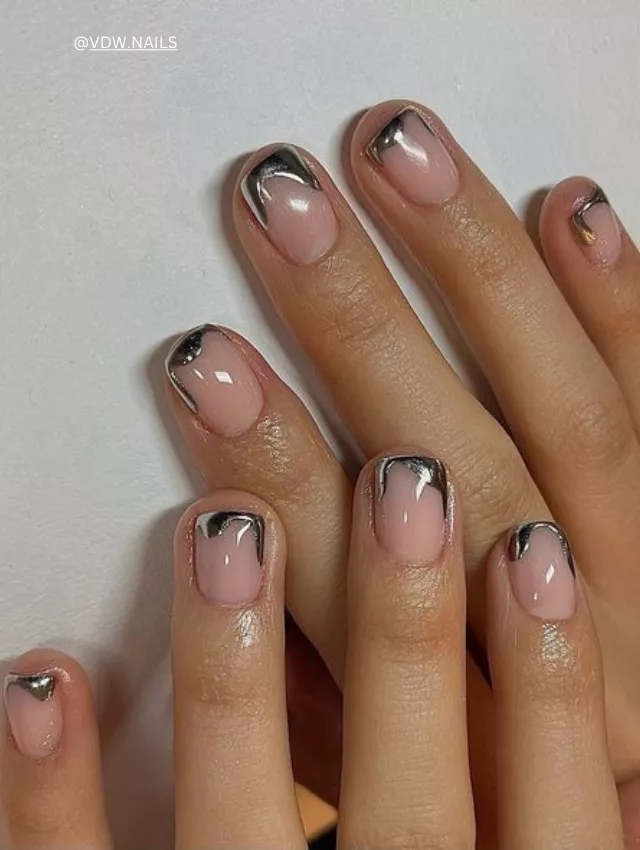 Short natural nails with silver chrome abstract French tips.