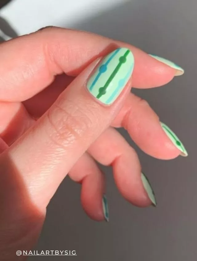 Minimalist springtime striped nail design in pastel green and blue
