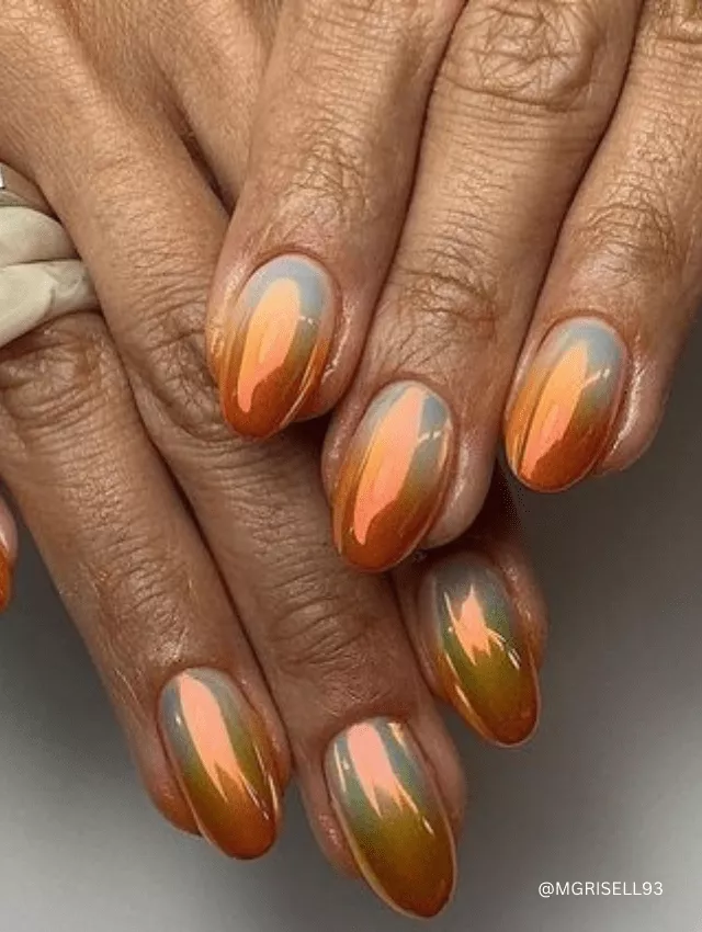 Almond-shaped nails with sunset-inspired ombre chrome polish.
