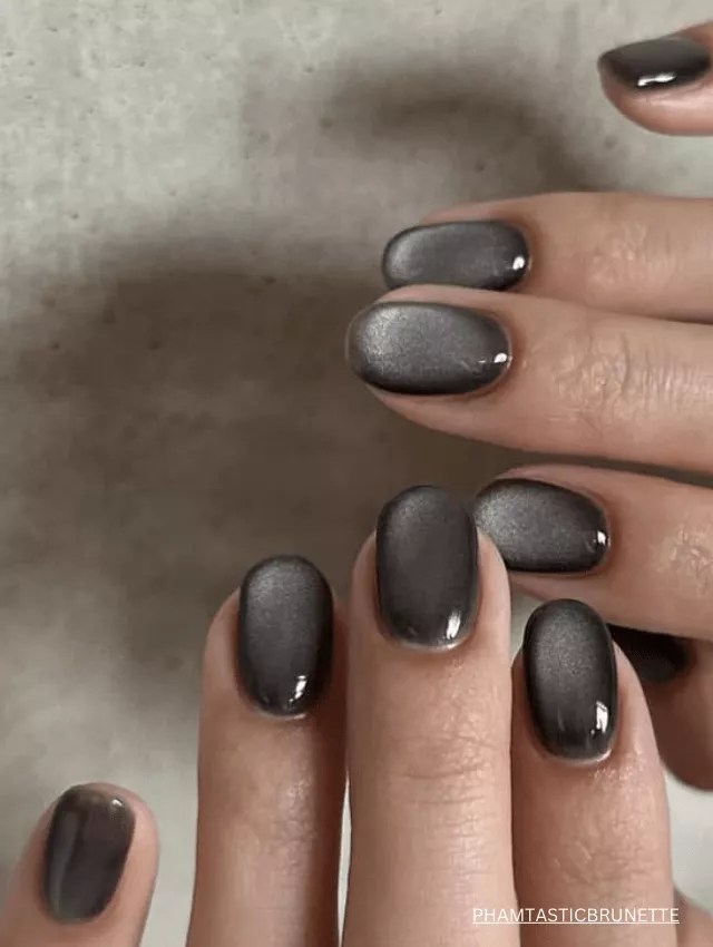 Sleek black velvet nails with a glossy, cat-eye effect.