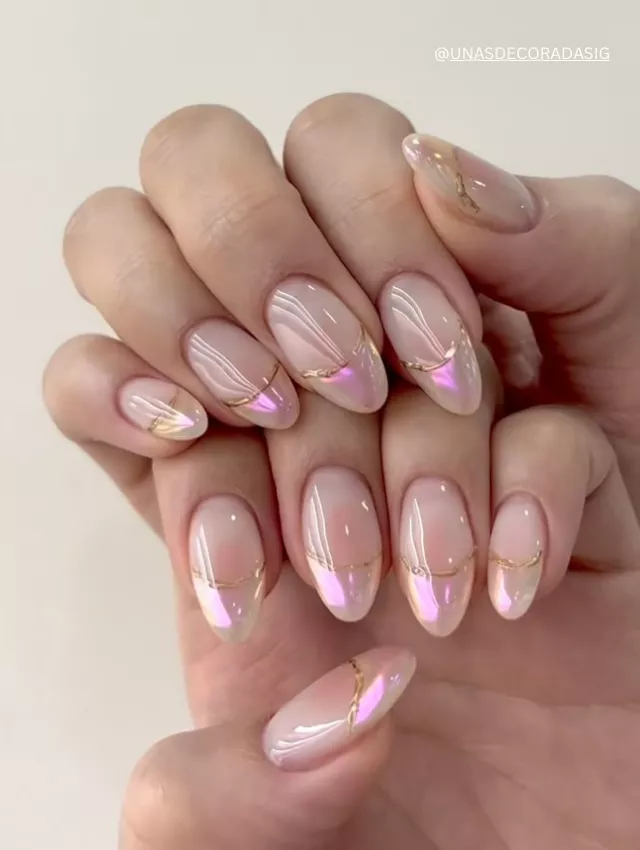  Soft pink iridescent French nails with delicate gold accents.