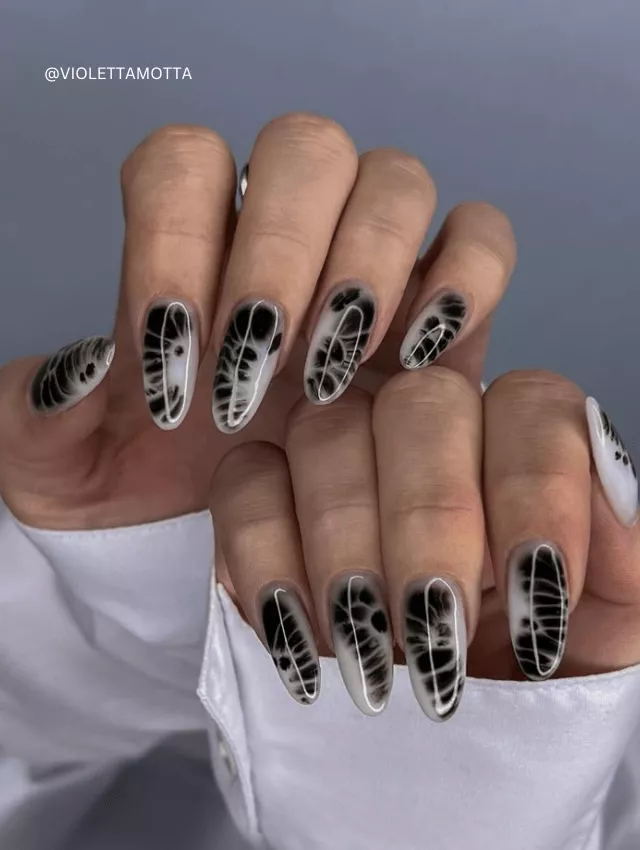 Black and white blooming smoke effect nails.