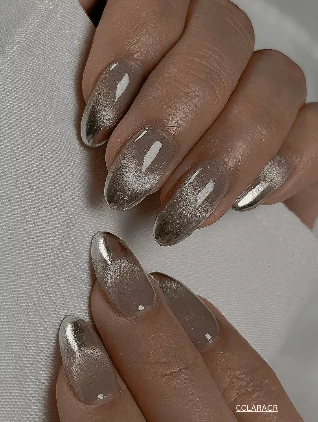 Soft nude velvet nails with a golden ombre shimmer.