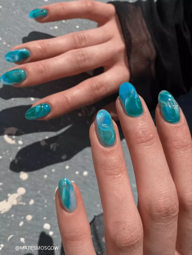 Wavy, ocean-inspired blue jelly nails with 3D details.