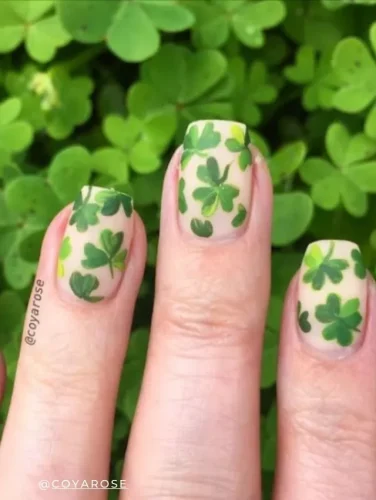 Delicate clover nail art on a sheer base, perfect for spring and St. Patrick's Day