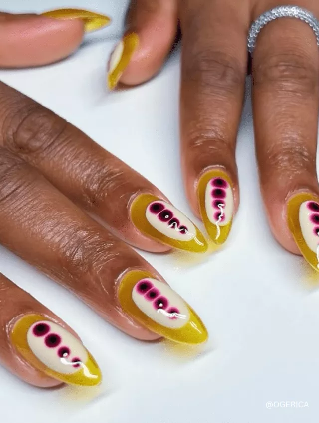 Bright yellow nails with pink and black blooming accents.