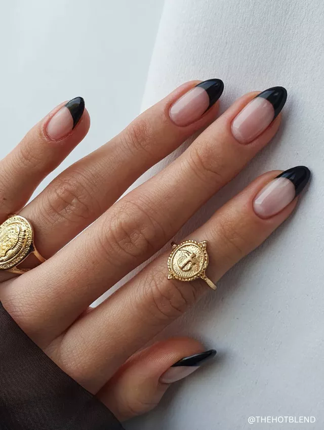 A modern black French tip nail design with a nude base and glossy finish.