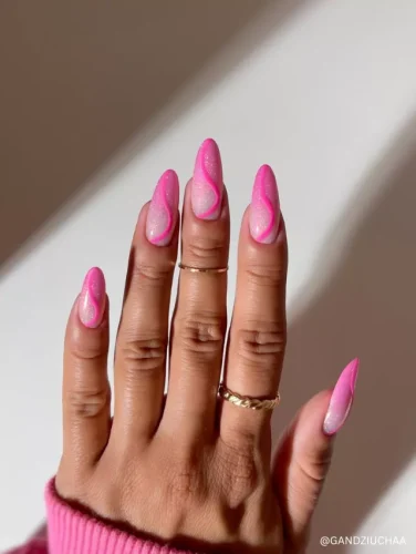 Vibrant almond-shaped nails with glittery pink waves and bold neon pink outlines for a trendy, dynamic look.