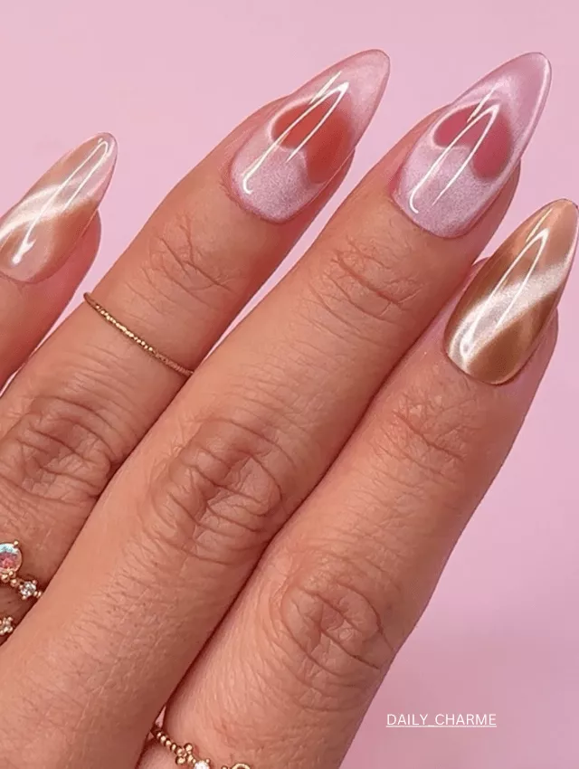 Soft blush pink velvet nails with golden heart-shaped tips.
