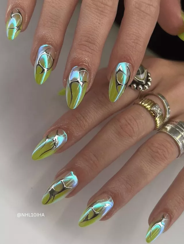 Long neon green and blue chrome nails with abstract black details.