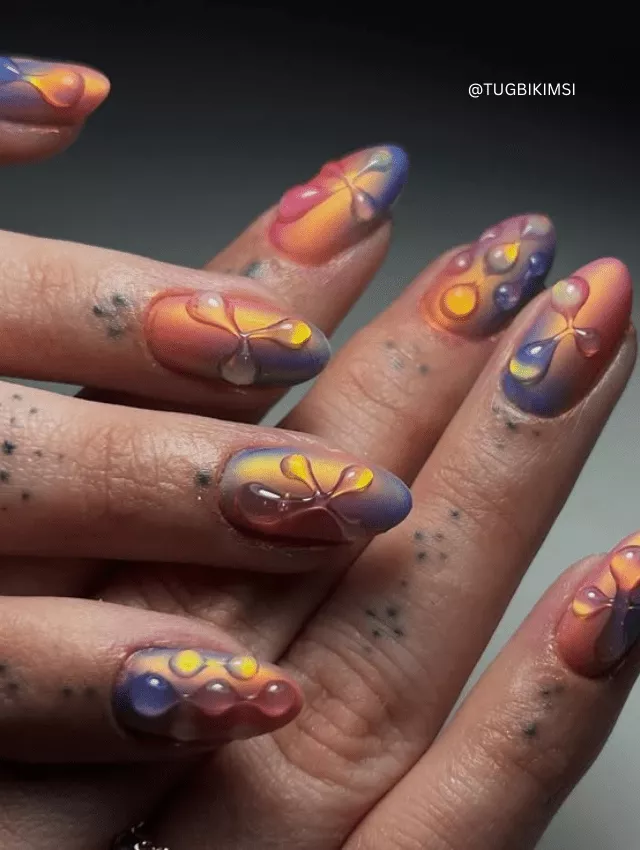 Sunset ombre nails with 3D blooming details.